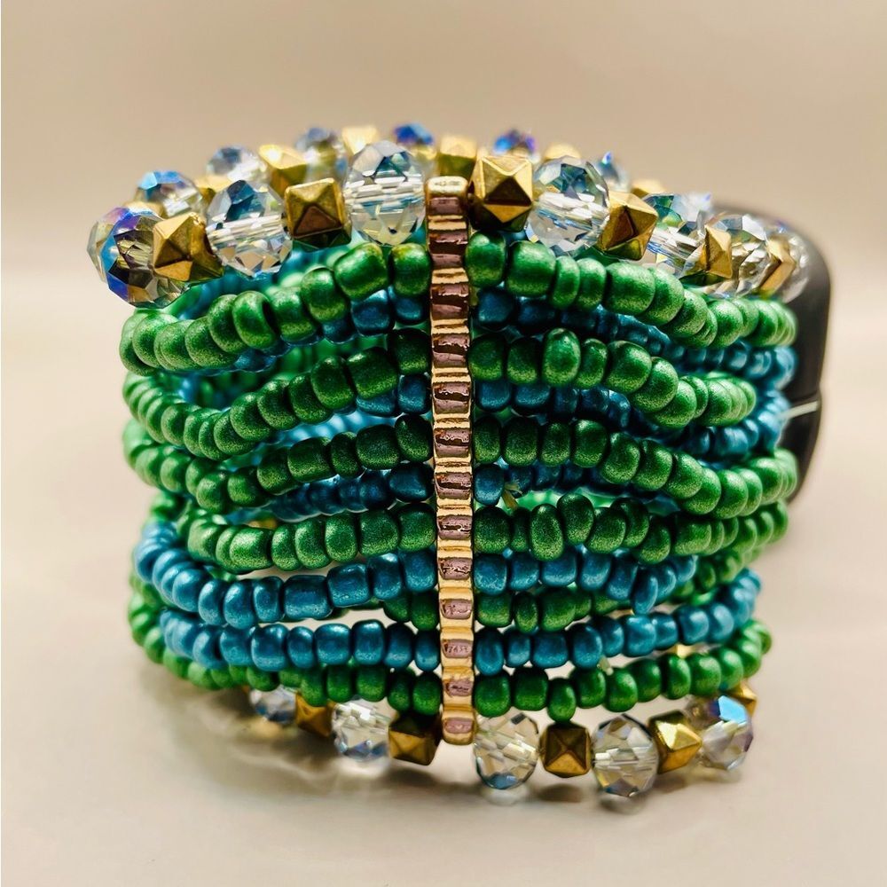 Turquoise mixed media beaded bracelet. Gold tone metal rods hold the beaded rows